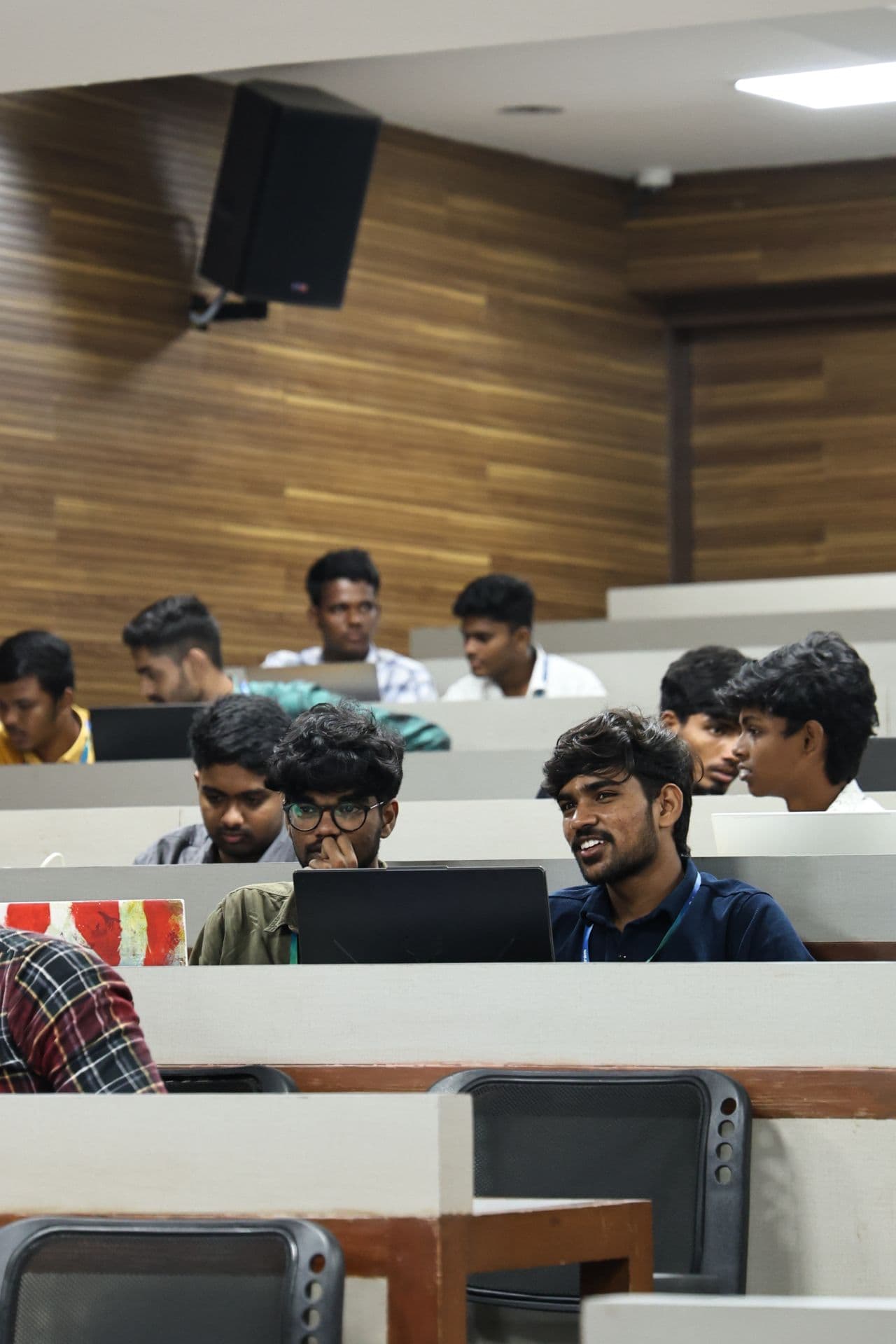 The hall mid-contest, laptops open across the rows